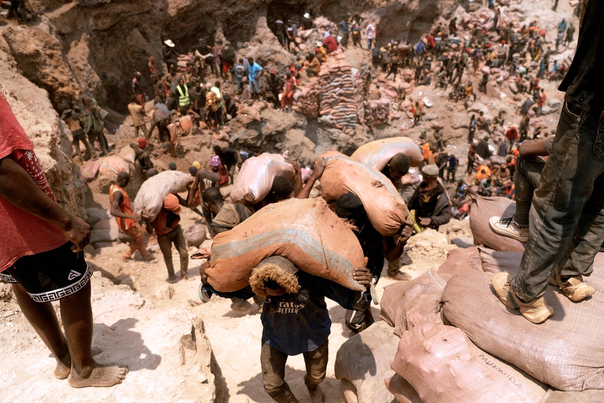 Miners carry sacks of cobalt ore at the Shabara artisanal mine near Kolwezi in the Congo