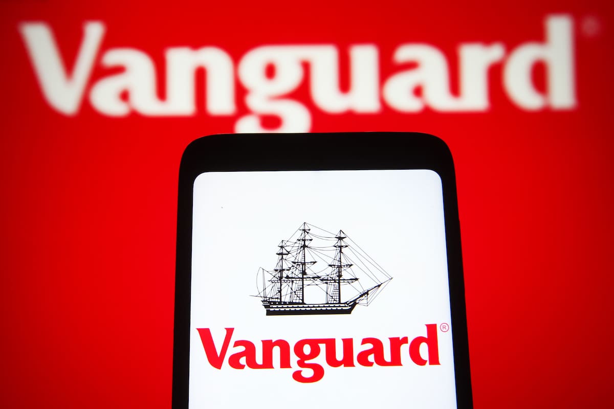 The Vanguard Group logo on a smartphone and in the background