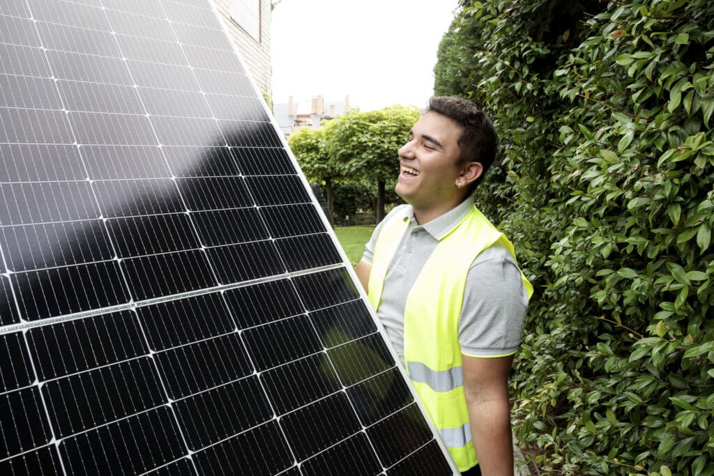 Solar technician holds a solar panel