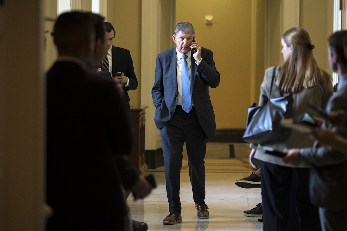 Sen. Joe Manchin (D-WV) talks on the phone at the U.S. Capitol in Washington, DC