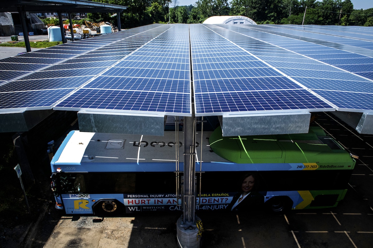 Solar panels make up the roof over parked buses at an electric bus terminal in Maryland
