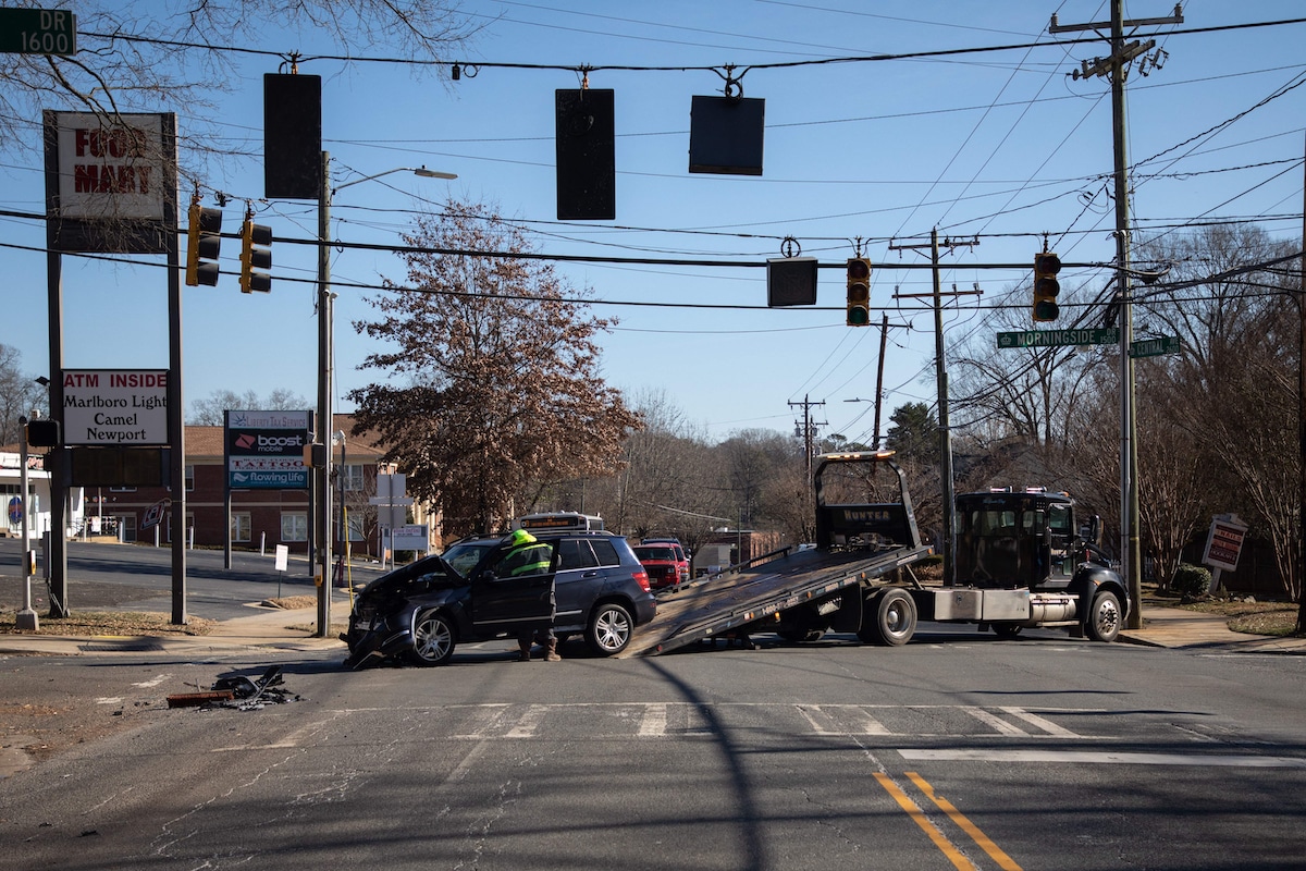 A car accident is cleared at an intersection without power to stop lights in Charlotte, North Carolina