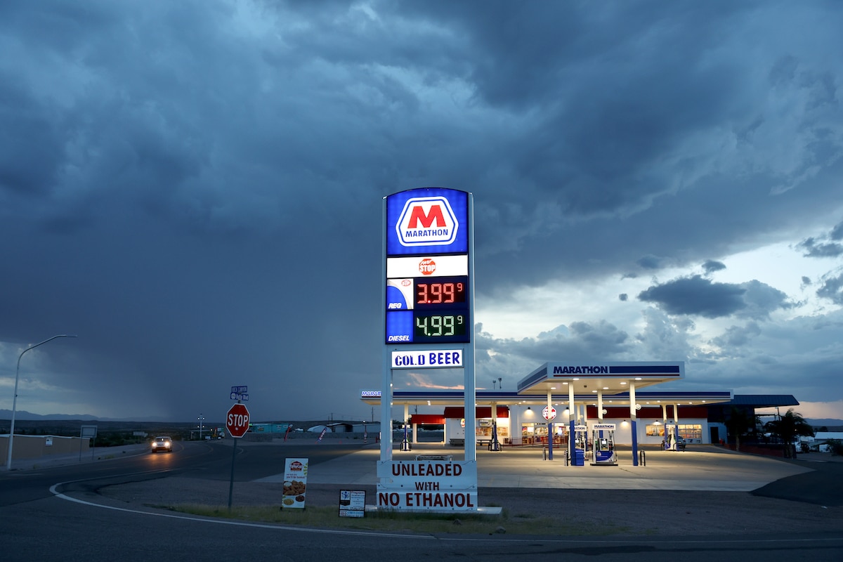 A gas station and a monsoon rain sky in the distance in New Mexico