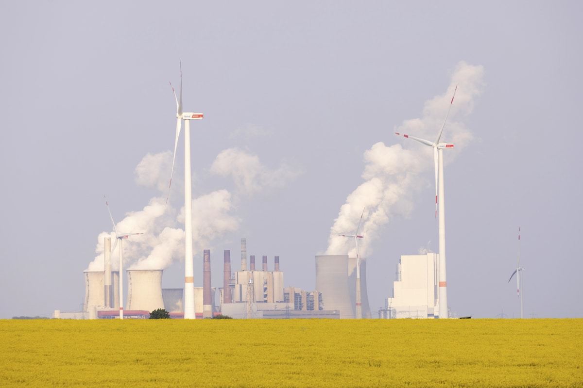 A coal-fired power plant and wind turbines at the Neurath power station near Bedburg, Germany