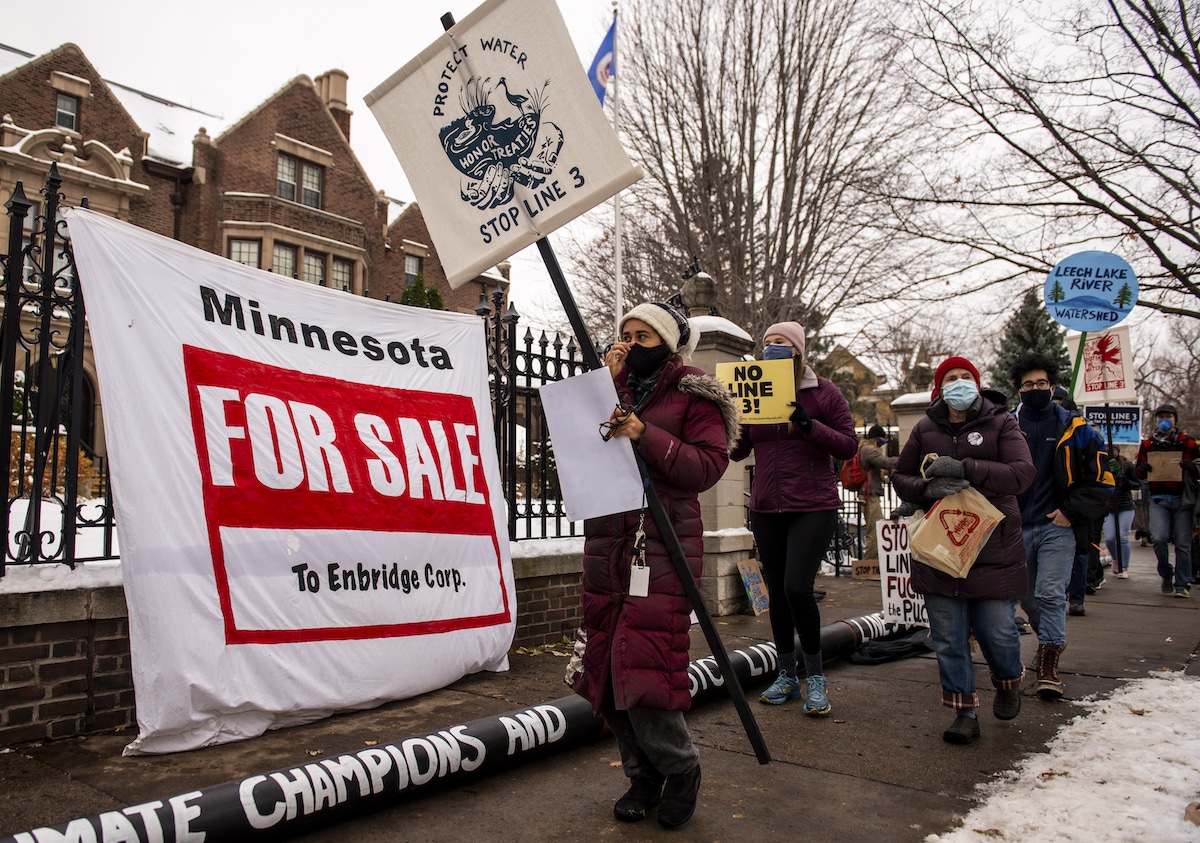 People protest against the Enbridge Energy Line 3 oil pipeline outside the Governor's Mansion in St Paul, Minnesota