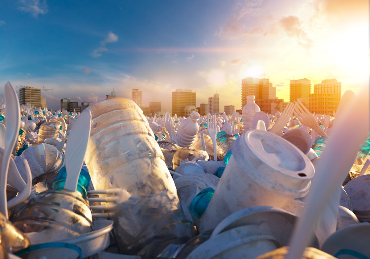 A digital illustration of an ocean wave made out of plastic waste with a city skyline and sunset in the background