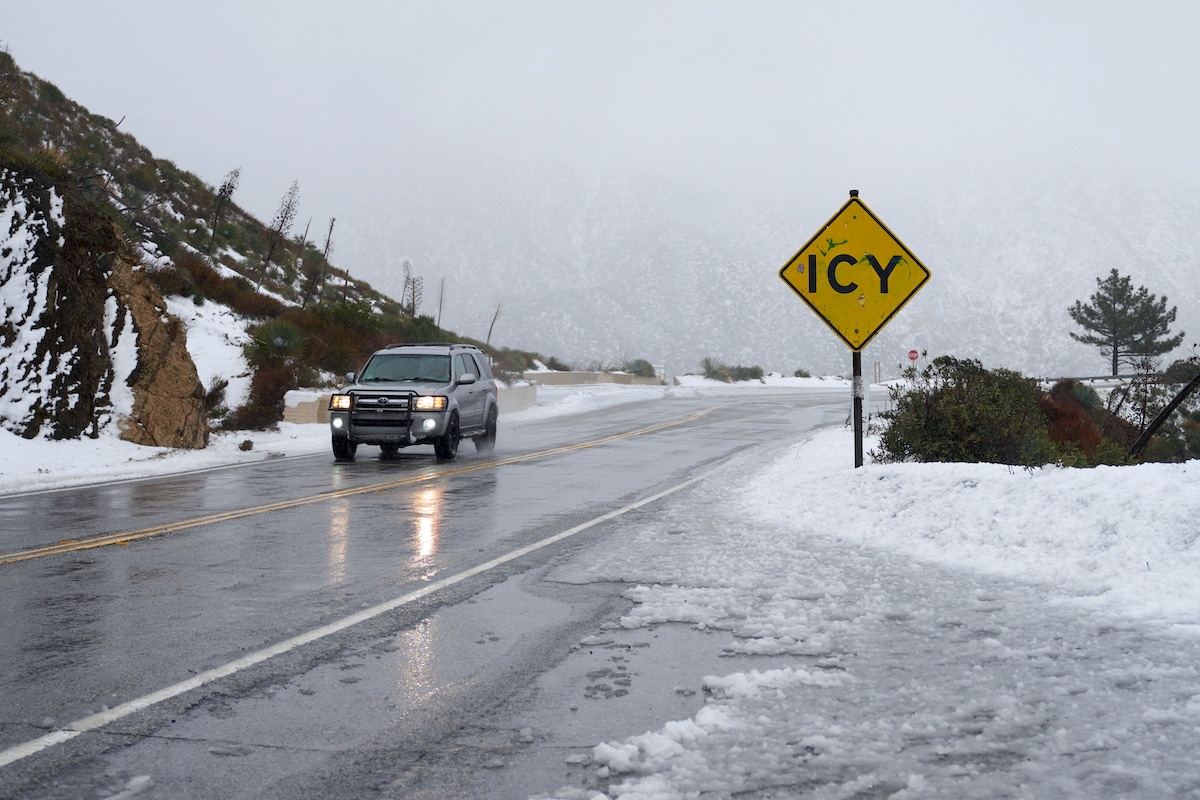 An SUV navigates an icy road in the San Gabriel Mountains in the Angeles National Forest, California
