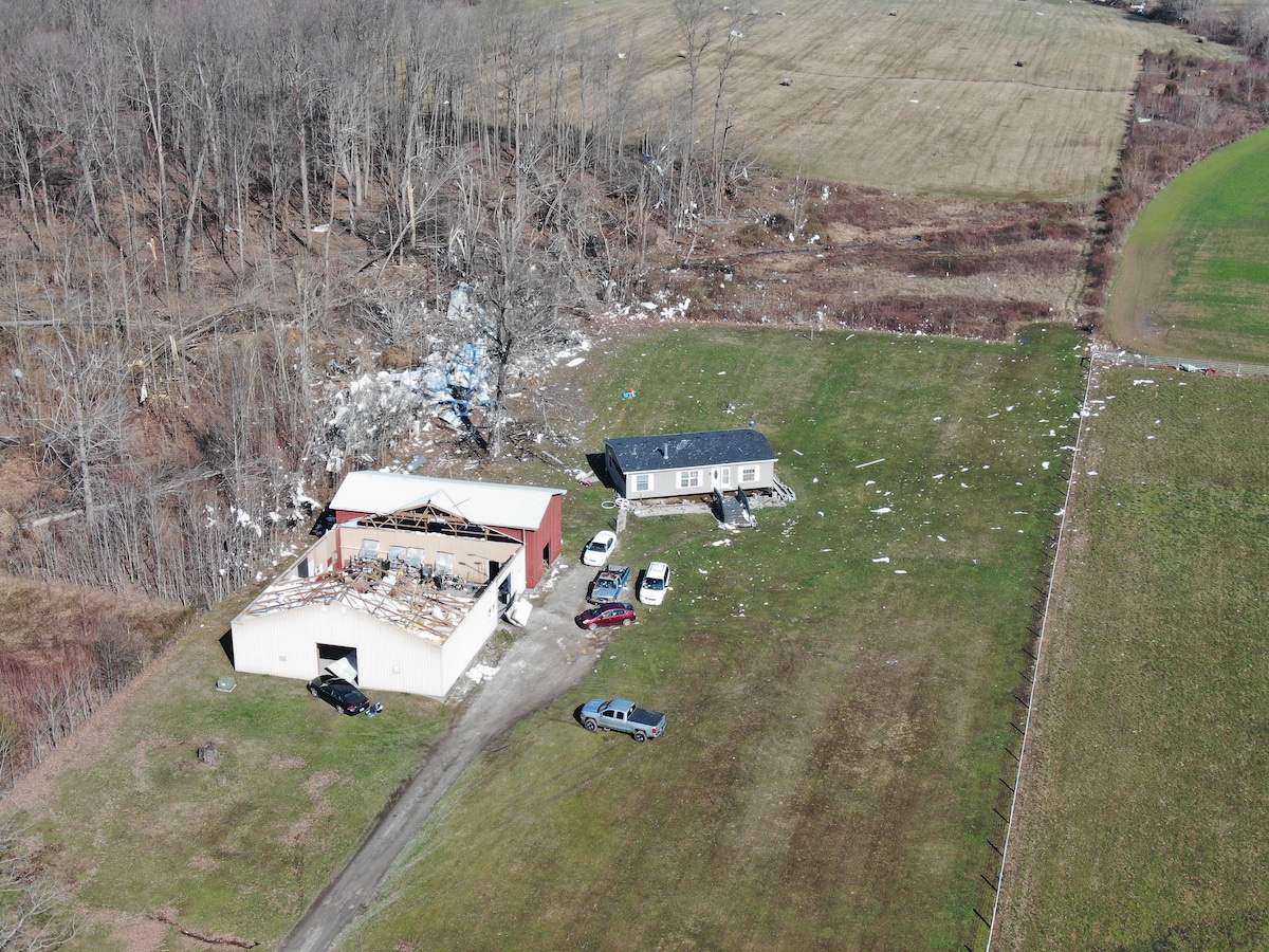 Damage from a tornado in Hanover, Indiana, including a barn with a large portion of its roof lifted