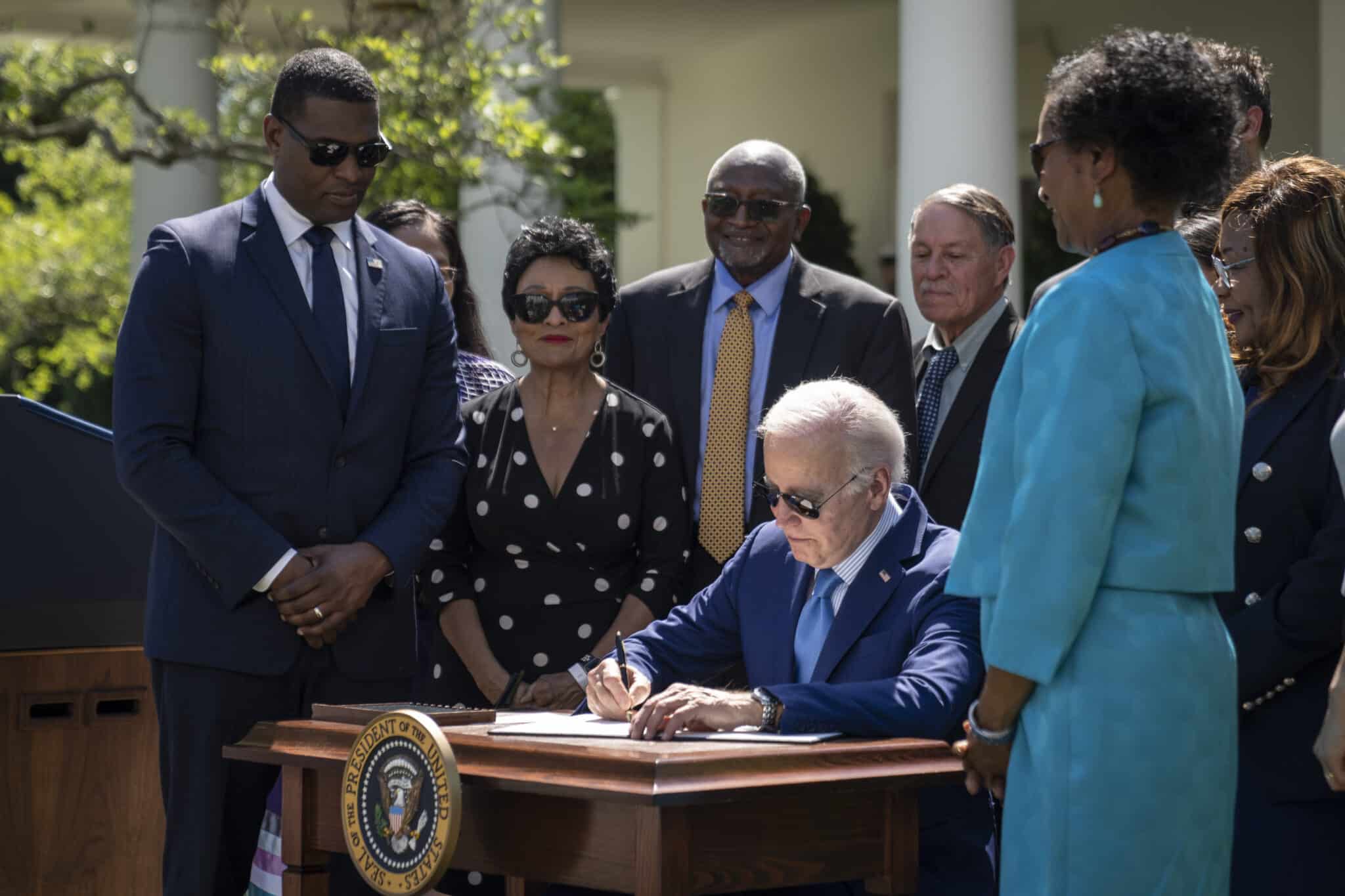 President Joe Biden signing an executive order in the Rose Garden
