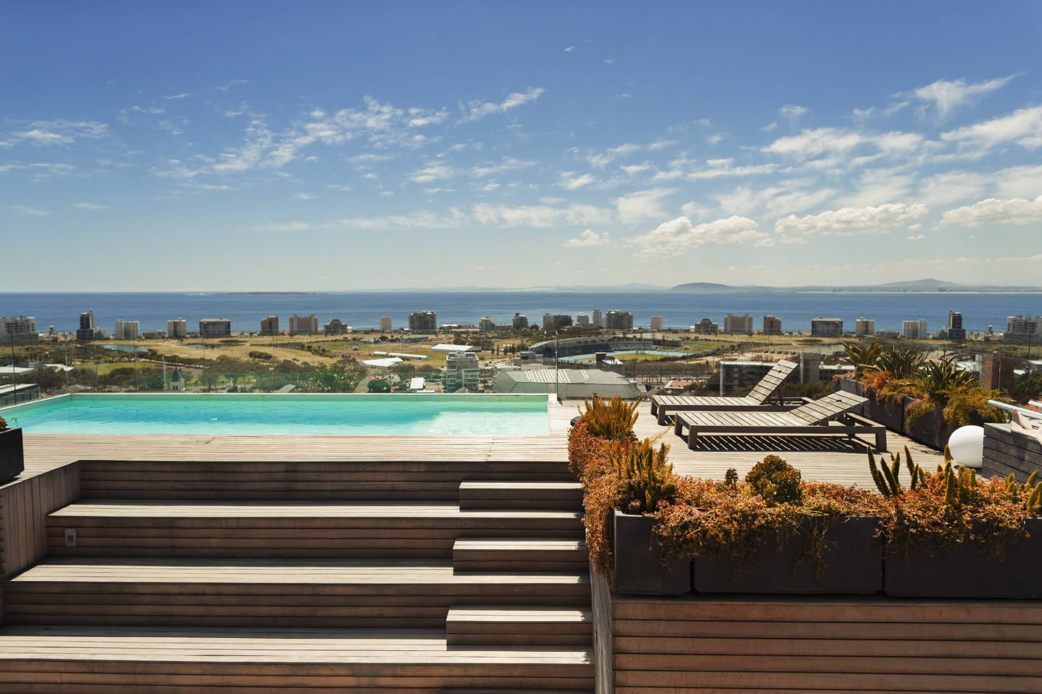 Sunny, modern rooftop swimming pool with ocean view, Cape Town, South Africa