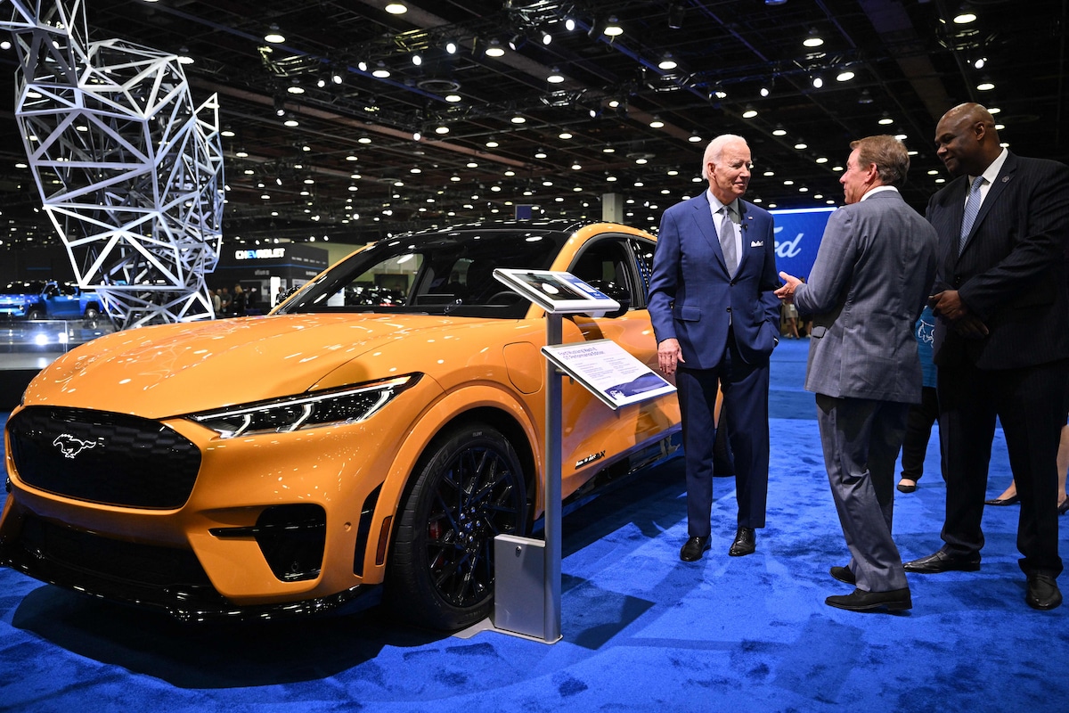 President Joe Biden discusses the electric Ford Mustang Mach-E with Ford Motor Company Executive Chairman William Clay Ford Jr. and President of the United Auto Workers Ray Curry