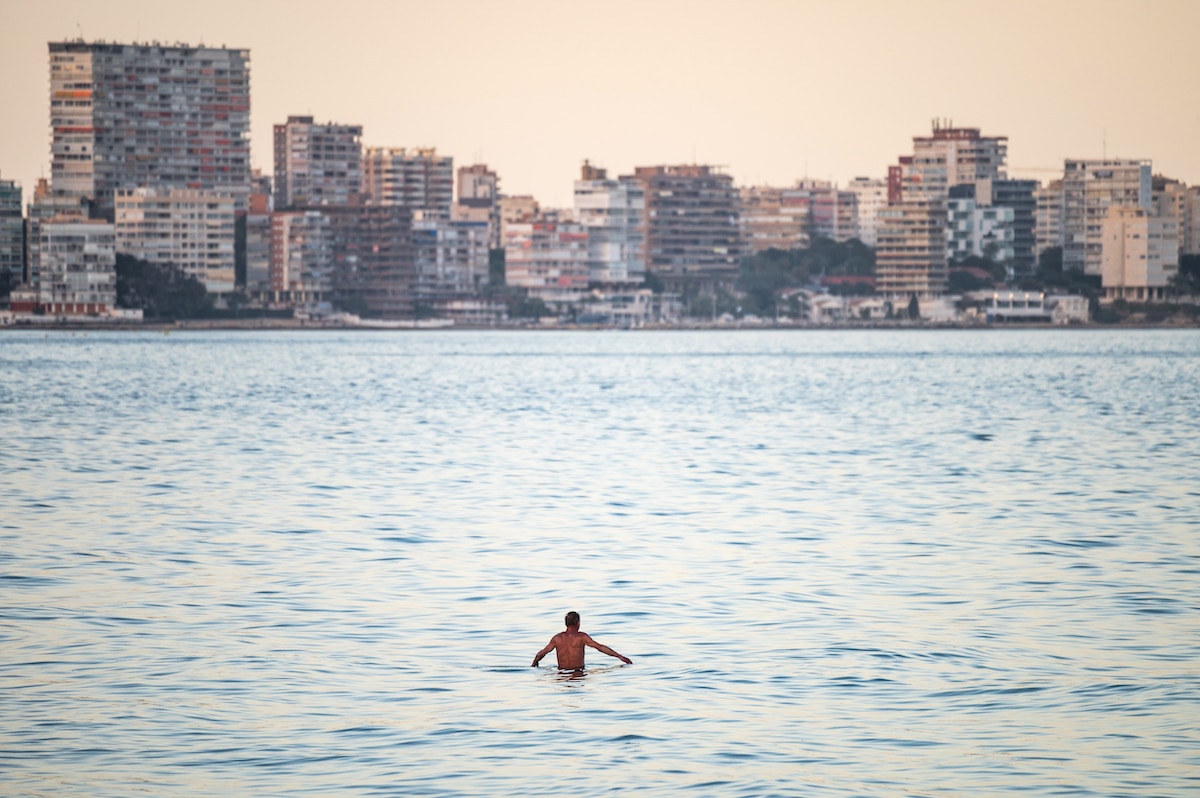 A man swims in the sea by the city of Alicante, Spain on April 1, 2023, the day ocean surface temperatures reached a record high