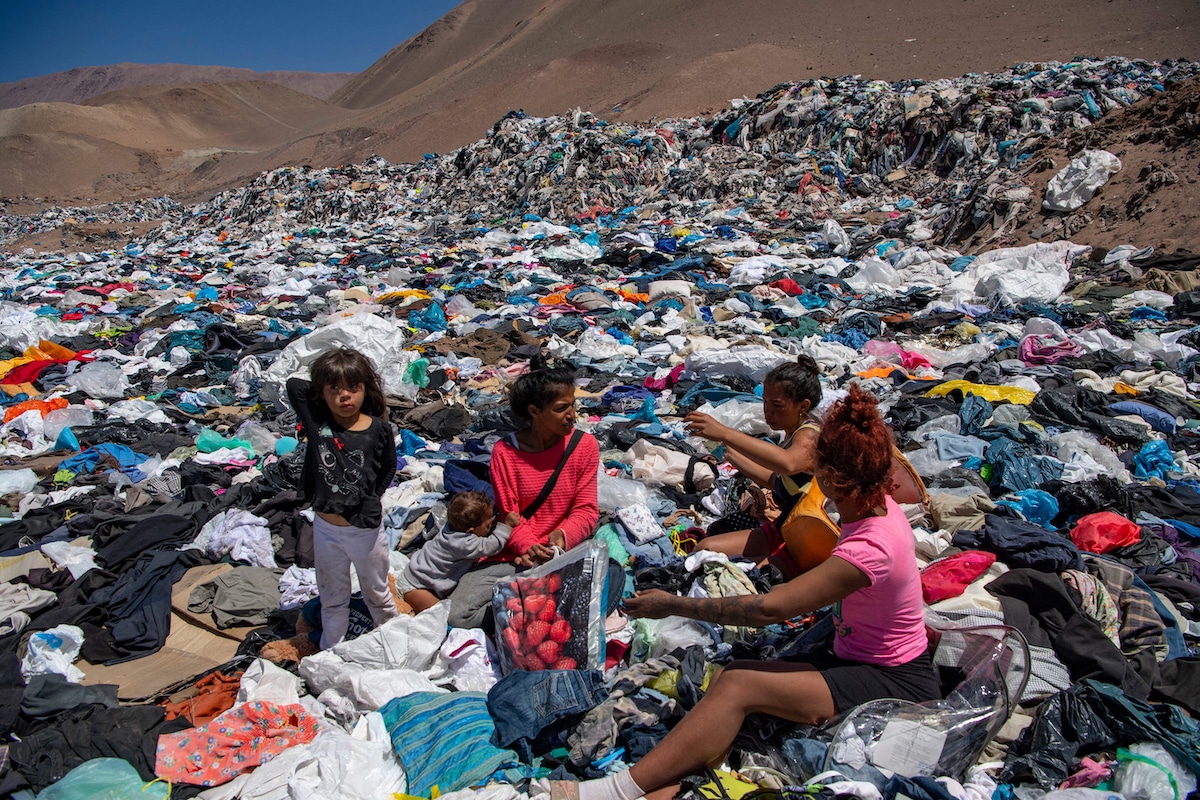 Women search for clothes among the tons of discarded items in Chile's Atacama Desert