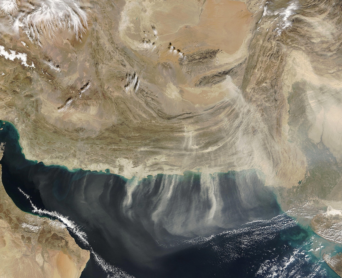 A NASA satellite image shows bands of dust blowing south over the Arabian Sea during a dust storm