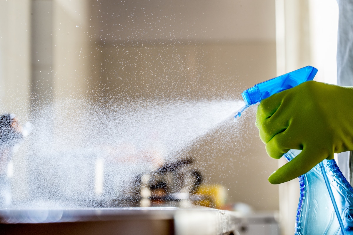 A cleaning product being sprayed on a kitchen counter