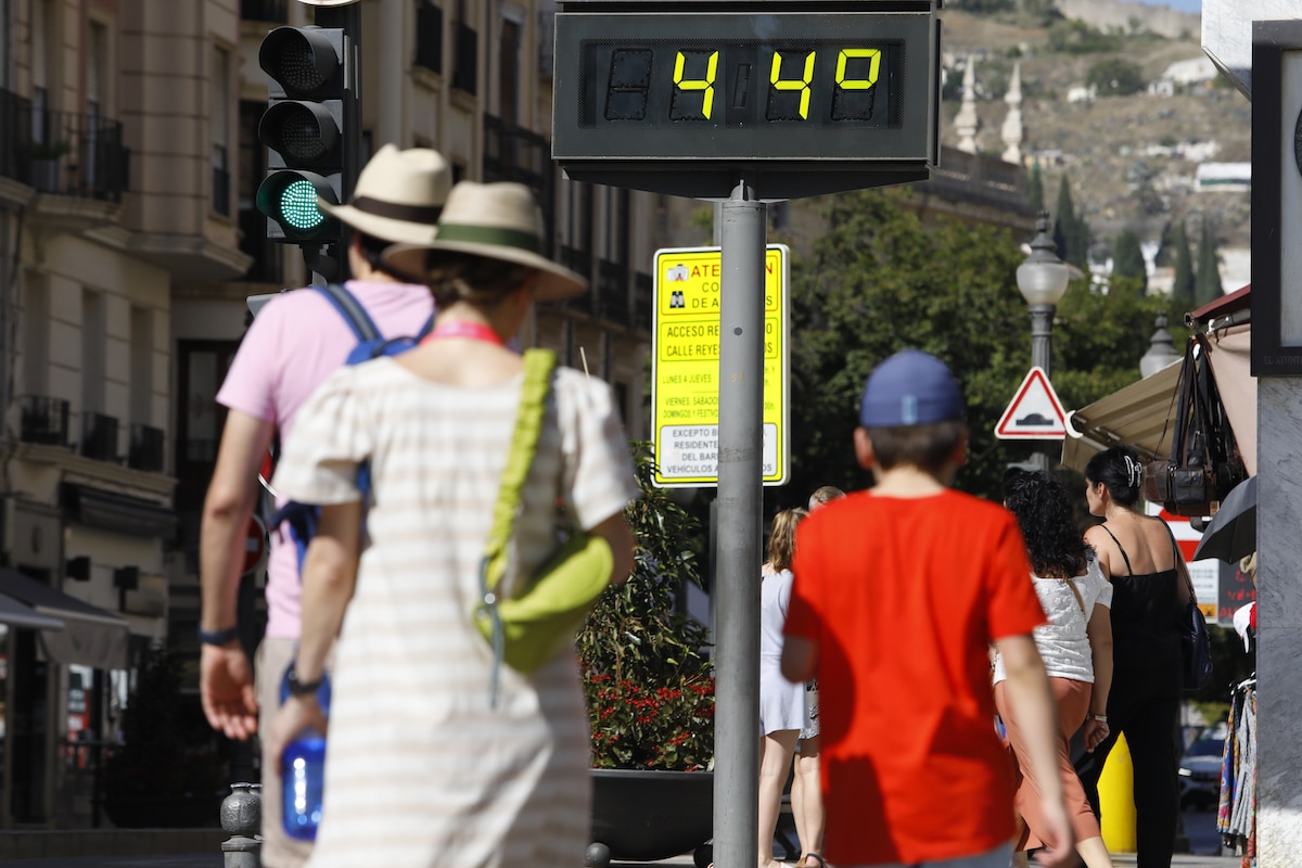 People walk on a street in Spain where temperatures reached 44°C (111°F) during a heat wave