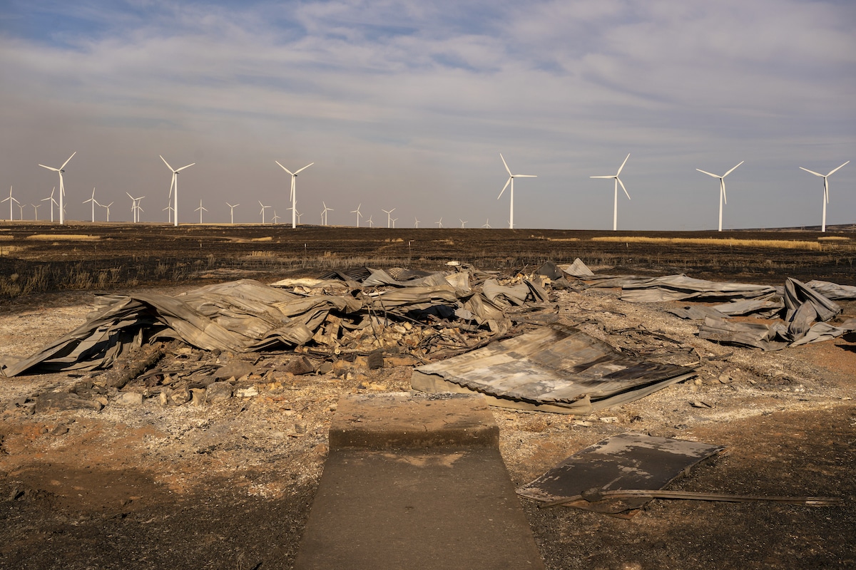 The burned remnants of an historic grange near a wind farm after the Newell Road Fire moved throug in Dot, Washington