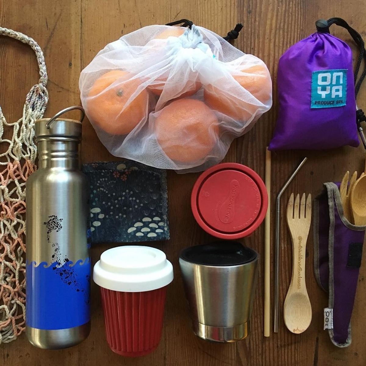 Plastic-free and reusable items including a water bottle, coffee cup, cutlery and food storage bags