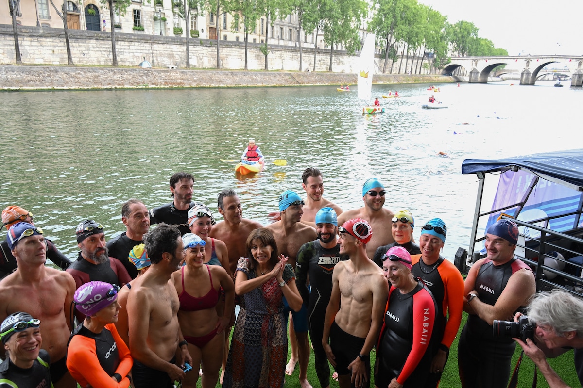 Paris Mayor Anne Hidalgo poses with swimmers as she announces the river Seine's bathing sites planned for Parisians in 2025