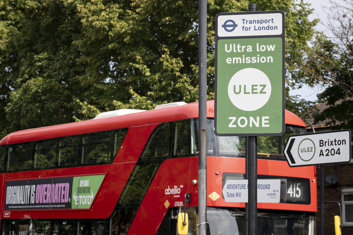 A local bus passes an ULEZ (Ultra Low Emission Zone) sign on the South Circular at Tulse Hill in London, England