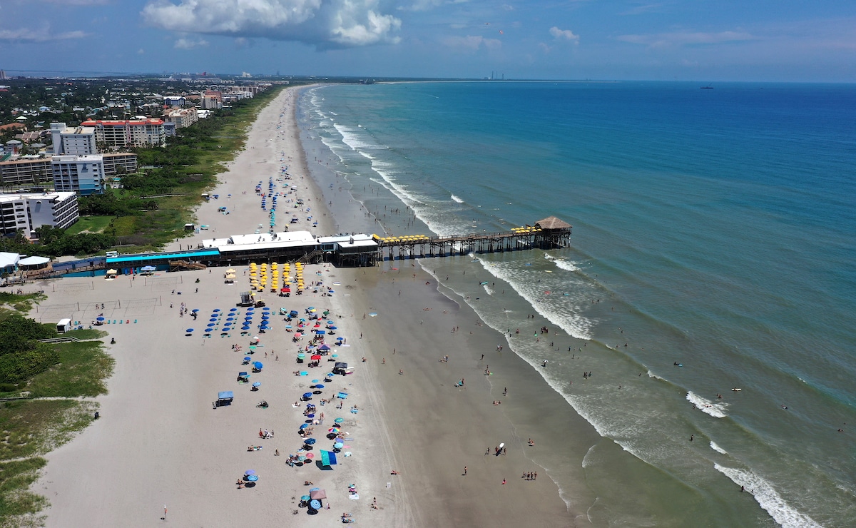 Aerial view of beachgoers near the pier in Cocoa Beach, Florida