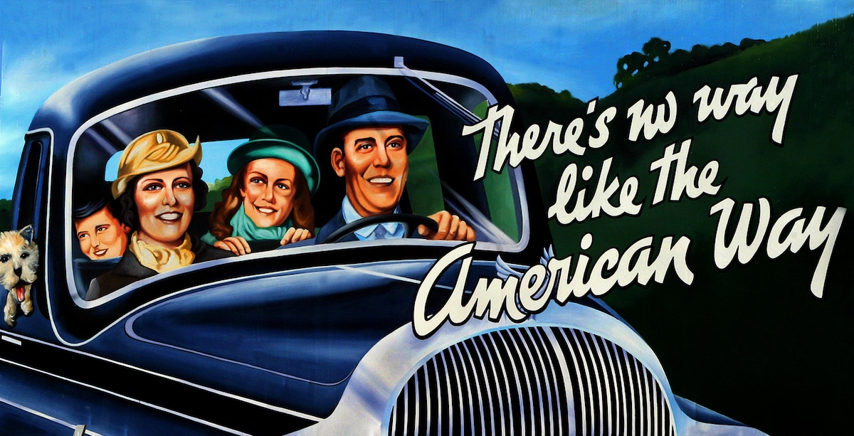 A painted reproduction of a famous propaganda billboard promoting driving in a car in America, at the site of the American City Diner in NW Washington, DC