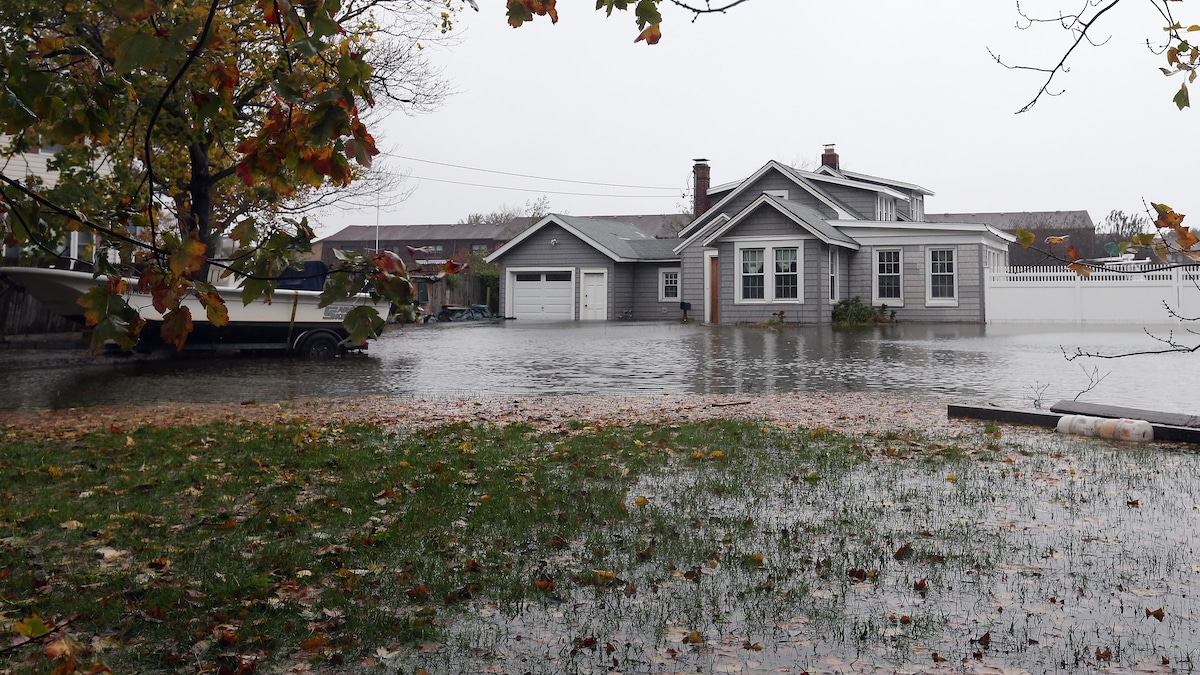 A house in Copiague, New York is partially submerged as high tide, rain and winds from Hurricane Sandy caused widespread damage in 2012