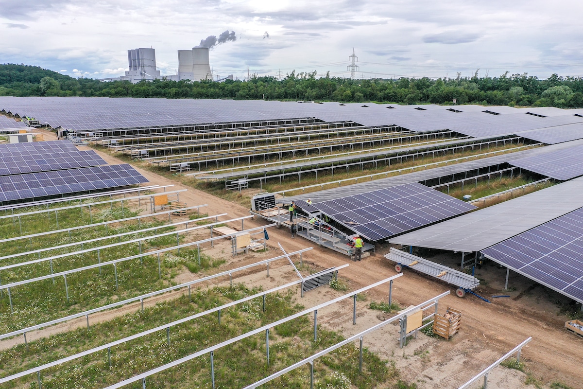 Workers assemble solar panels at the Witznitz Energy Park in Neukieritzsch, Germany