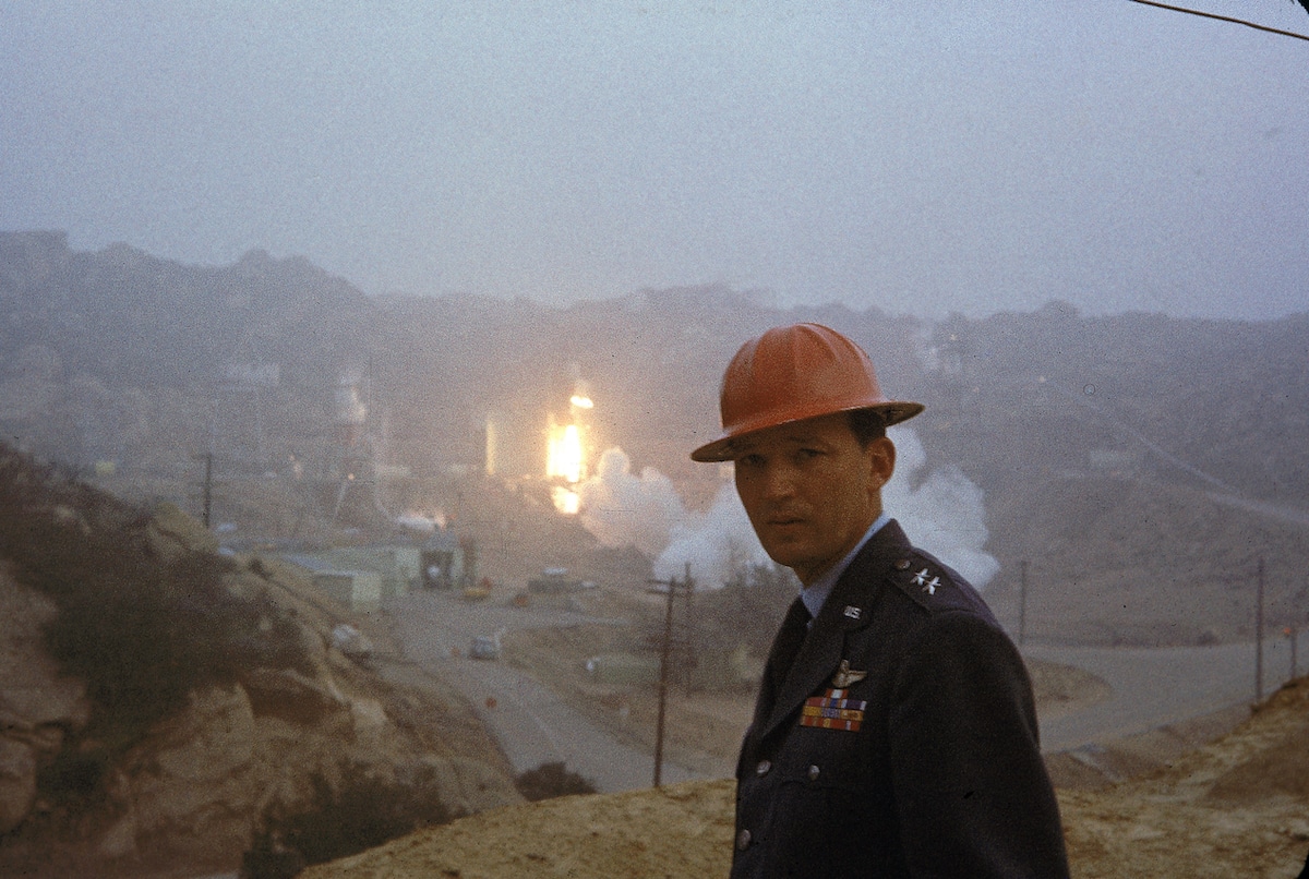 Founder of the U.S. Air Force's space and ballistic missile program Major General Bernard A. Schriever stands near the rocket engine test firing grounds during a test firing at the Santa Susana Field Laboratory