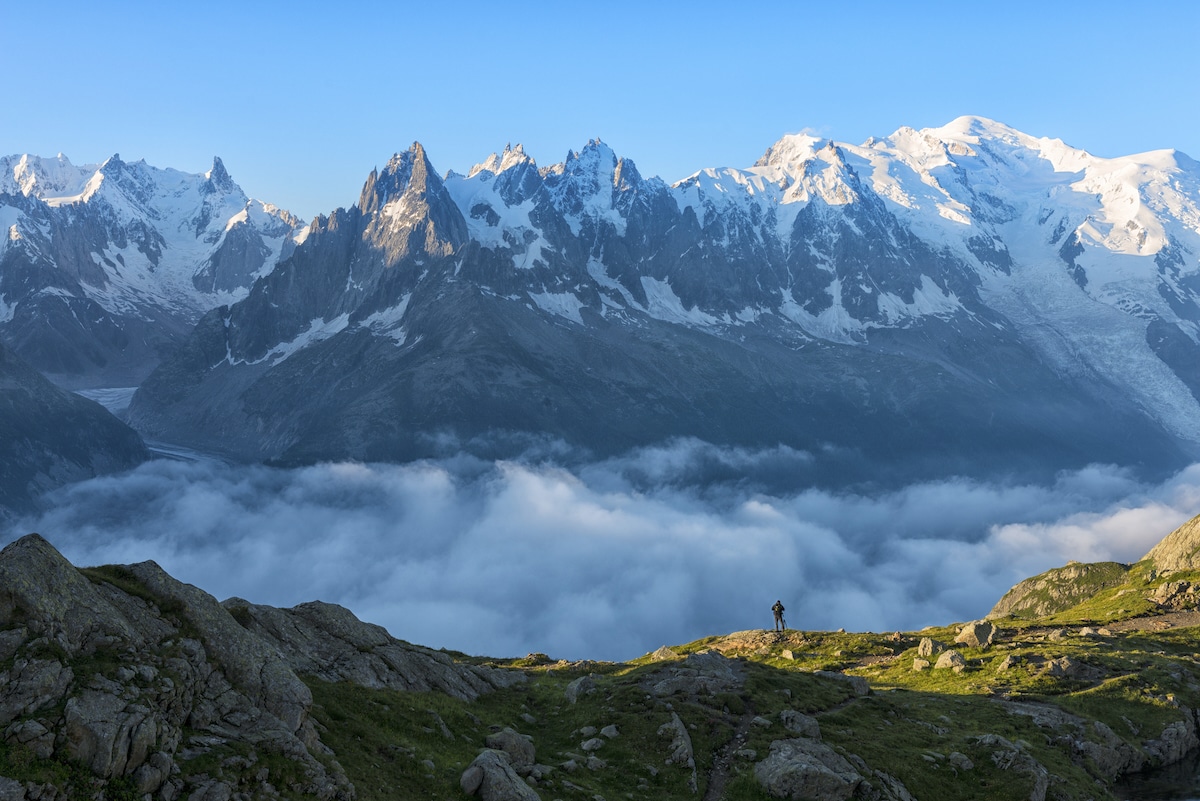 A hiker in front of Mount Blanc at sunrise