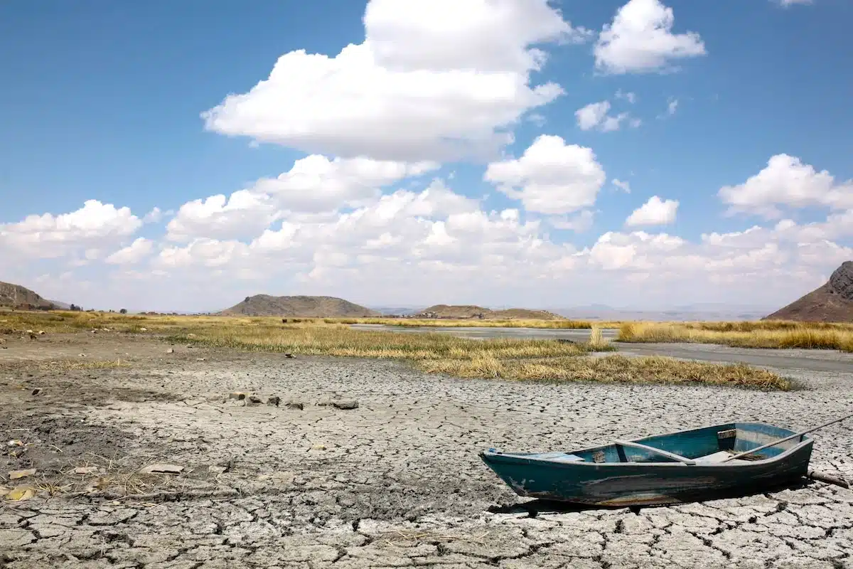 A boat in a dry part of Lake Titicaca — the world’s highest navigable lake — in Huarina, Bolivia during a heat wave this September