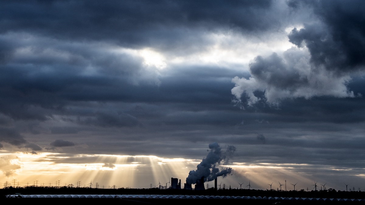 The sun shines behind clouds moving over the Niederaussem coal-fired power plant in North Rhine-Westphalia, Germany