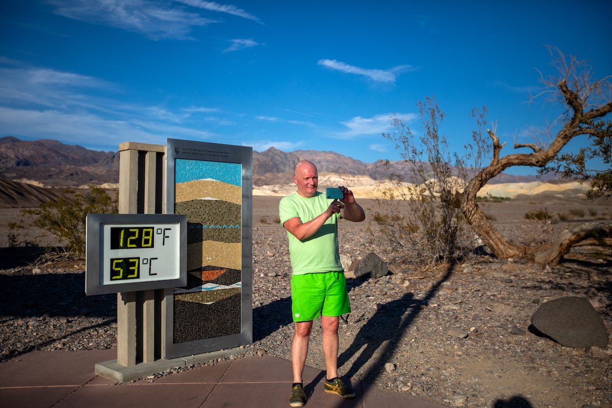 A tourist takes a selfie at the National Park Furnace Creek Visitor Center in Death Valley, California on July 16, 2023, when the thermometer showed 128 degrees Fahrenheit