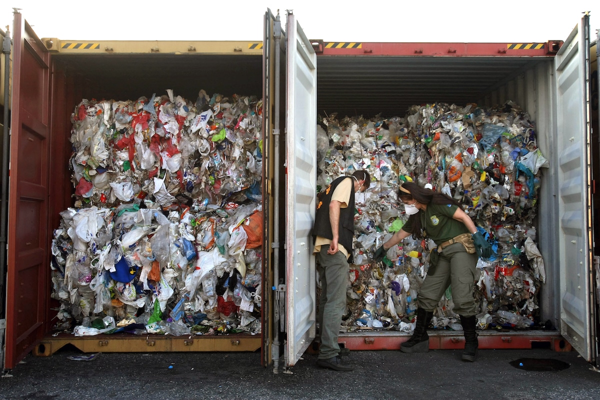 Agents of Brazil's state environmental agency inspect containers coming from Britain containing household waste improperly labeled as recyclable plastic, in the port of Santos, São Paulo, Brazil