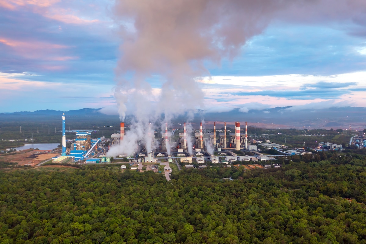 Aerial view of a coal-fired power plant surrounded by trees in Lampang, Thailand