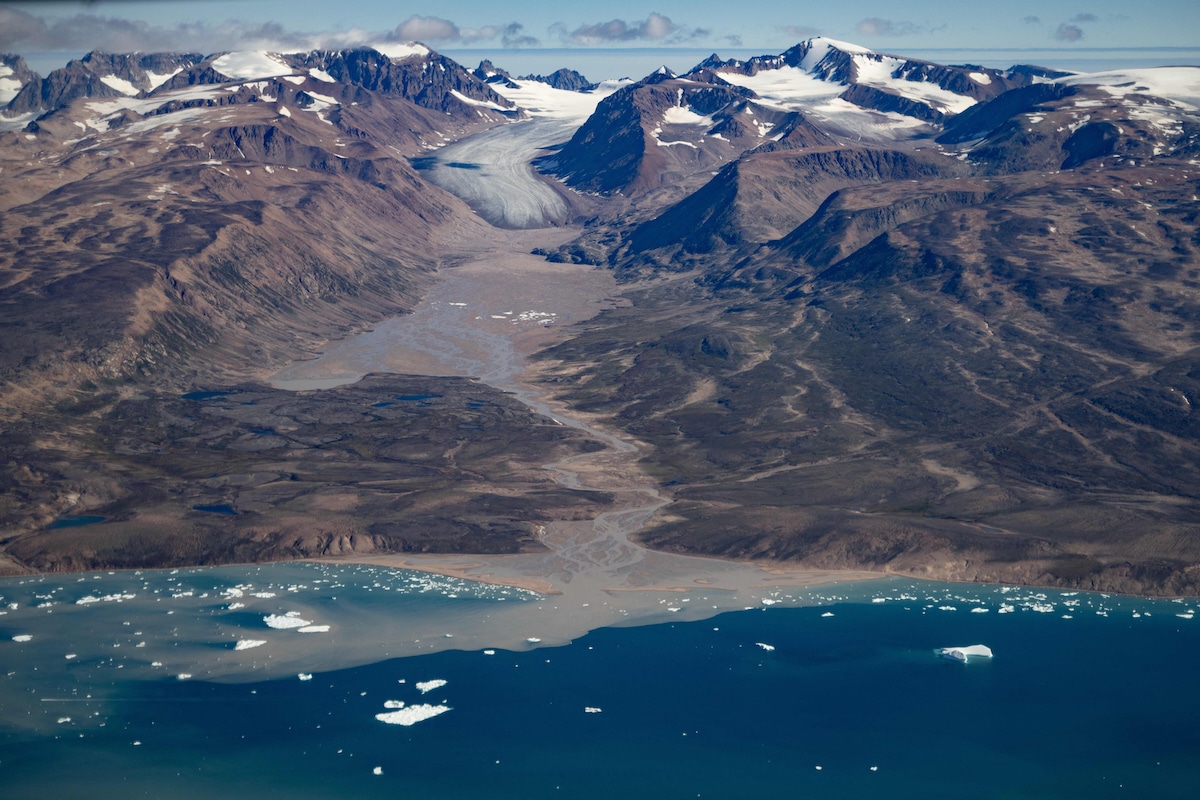 Aerial view of a severely melted glacier due to warm temperatures along the Scoresby Sound Fjord in Eastern Greenland