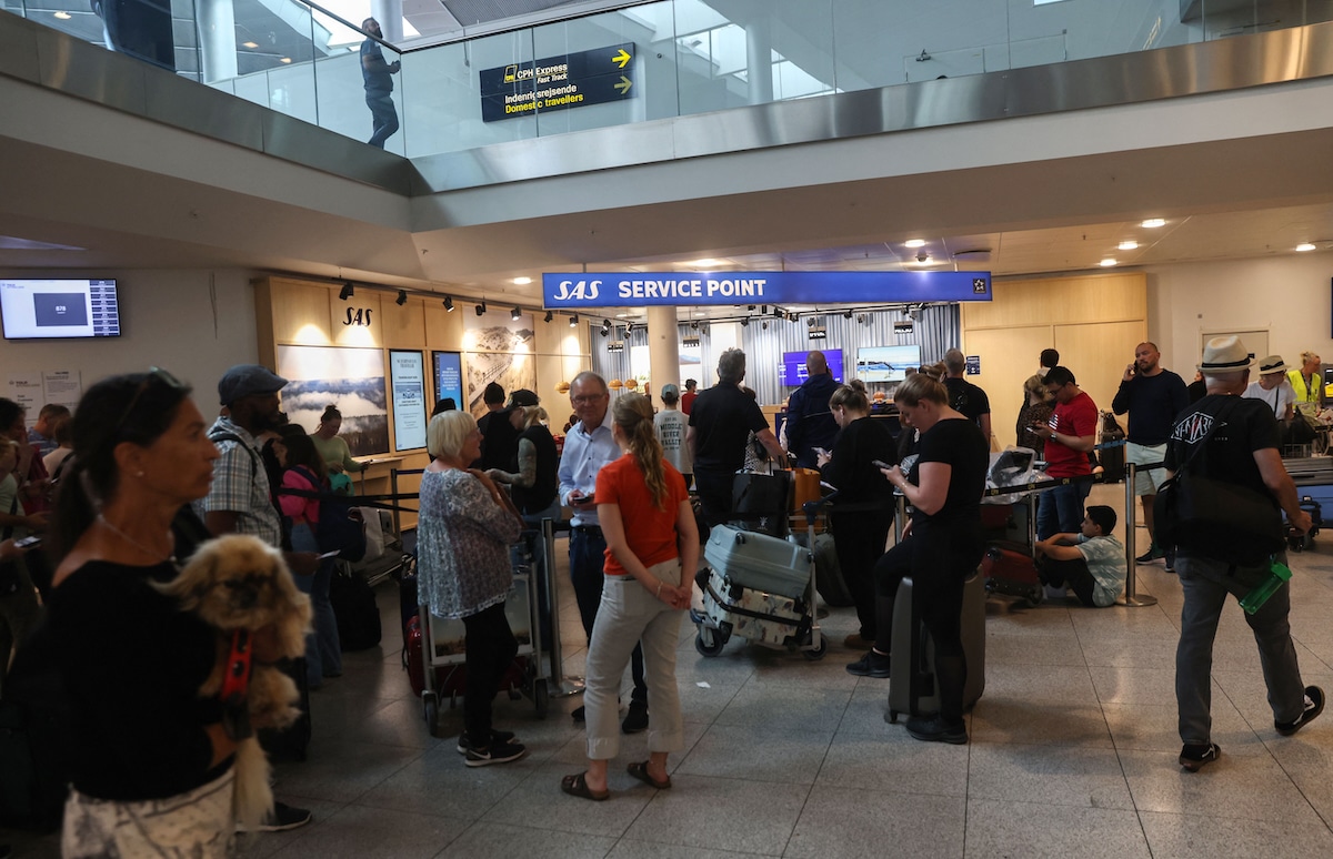 Passengers at the booths of Scandinavian airline SAS in the departure hall at Copenhagen Kastrup airport