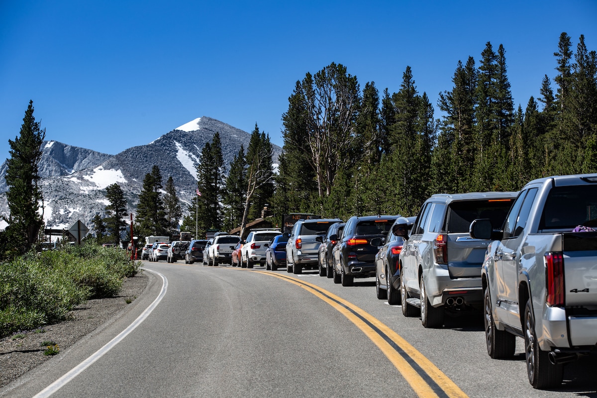 A long line of cars approaches the Tioga Pass Highway 120 entrance of Yosemite National Park in California