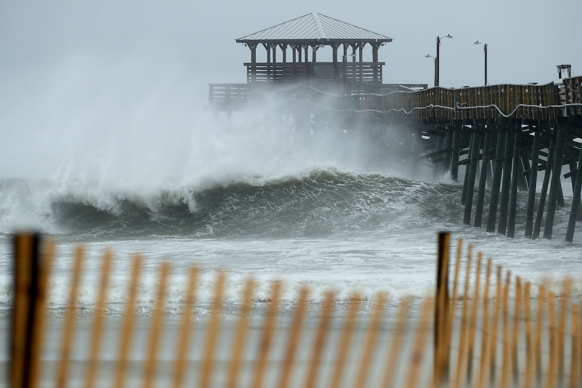 Waves crash underneath the Oceanana Pier as the outer bands of Hurricane Florence reach the coast in Atlantic Beach, North Carolina