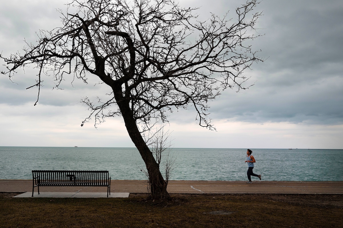 A jogger runs along Lake Michigan as temperature climbed to near 60°F, more than 20 degrees above normal in Chicago, Illinois