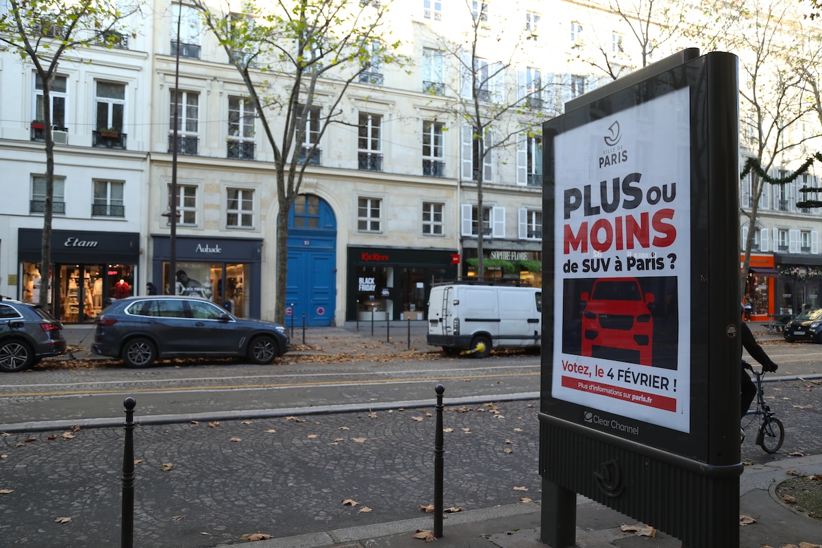 A street billboard informs the public about the referendum on parking fees for SUVs in Paris, France