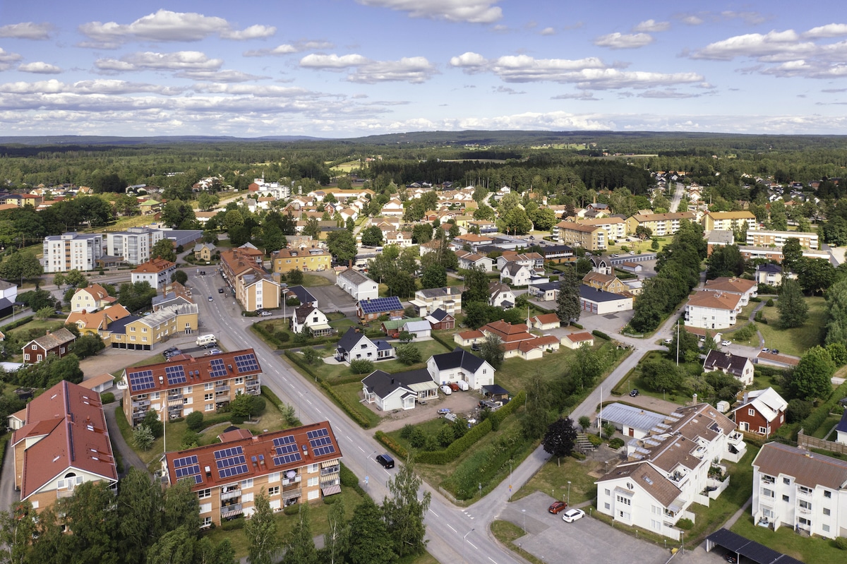 Aerial view of the town of Tibro in the Västergötland province of Sweden shows many homes and buildings with rooftop solar panels