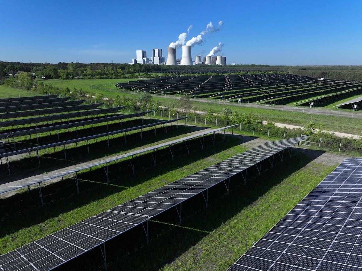 The Boxberg coal-fired power plant stands behind the newly inaugurated PV-Park Boxberg solar energy park in Nochten, Germany