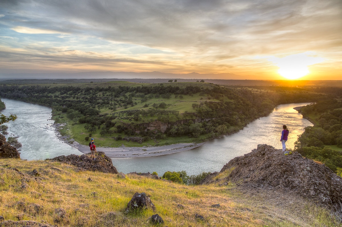Hikers look out over the Sacramento River Bend Outstanding Natural Area in Red Bluff, California