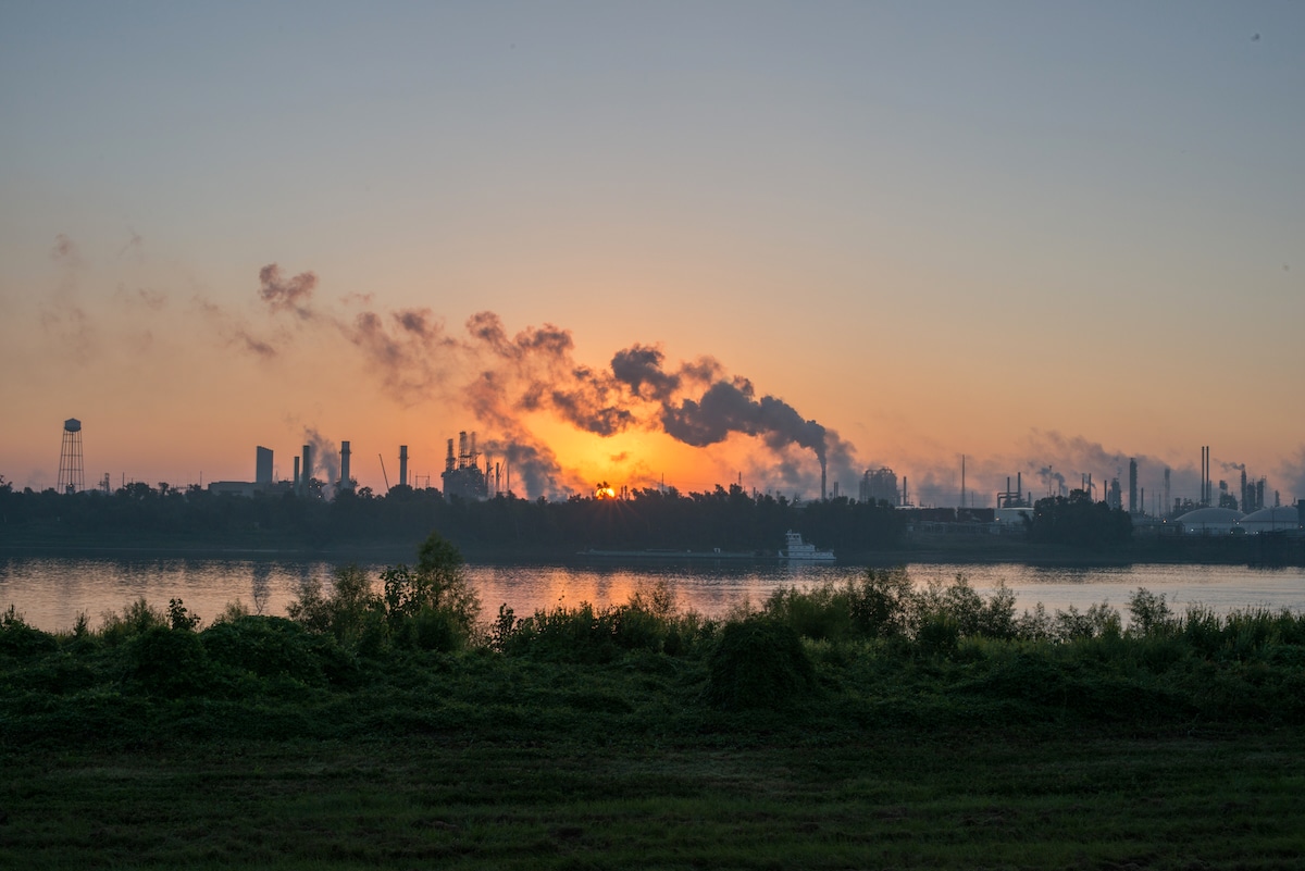 Smoke billows from chemical plants over an industrial and residential area of Baton Rouge, Louisiana known as “Cancer Alley”