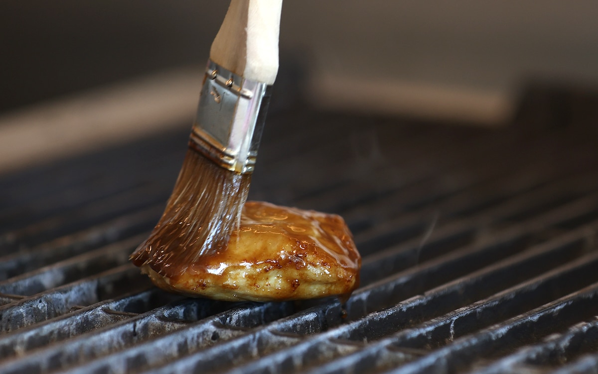 A chef brushes sauce on a piece of Good Meat's cultivated chicken at the Eat Just office in Alameda, California